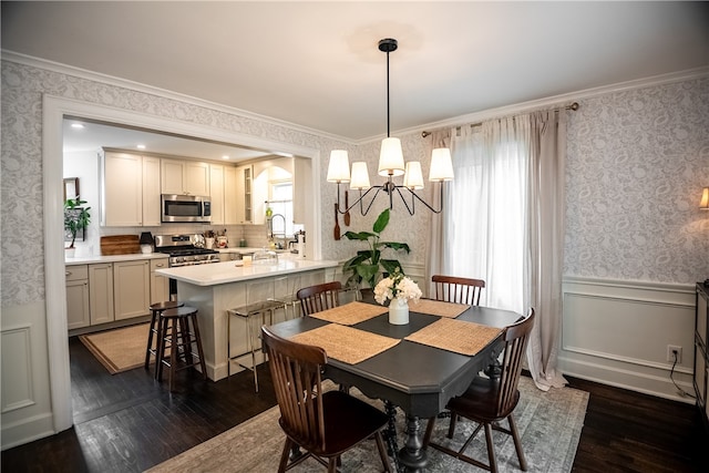 dining room featuring an inviting chandelier, ornamental molding, and dark hardwood / wood-style flooring