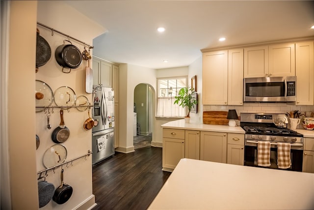 kitchen featuring appliances with stainless steel finishes, backsplash, and dark hardwood / wood-style flooring