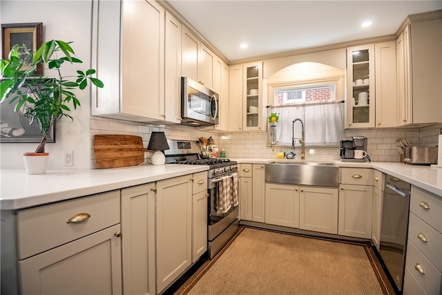 kitchen with stainless steel appliances, tasteful backsplash, and sink