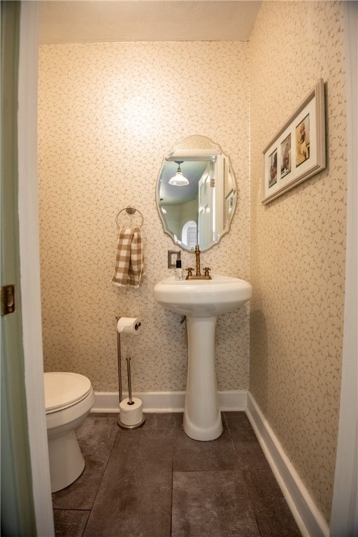 bathroom with tile patterned flooring, sink, and toilet