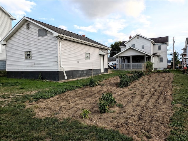 rear view of property with a lawn