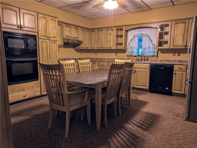 carpeted dining room featuring a drop ceiling, sink, and ceiling fan