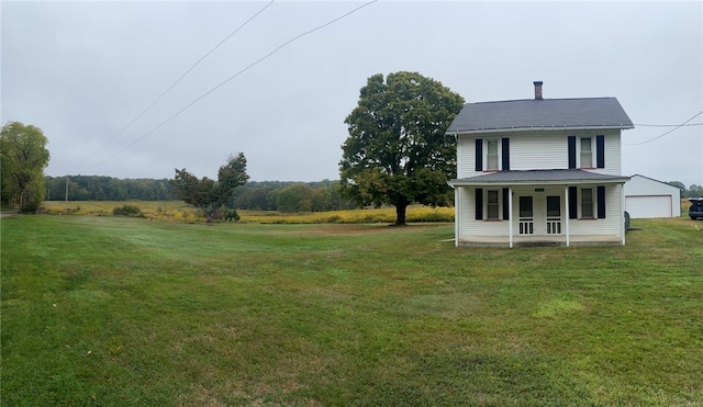 view of yard with a porch and a garage