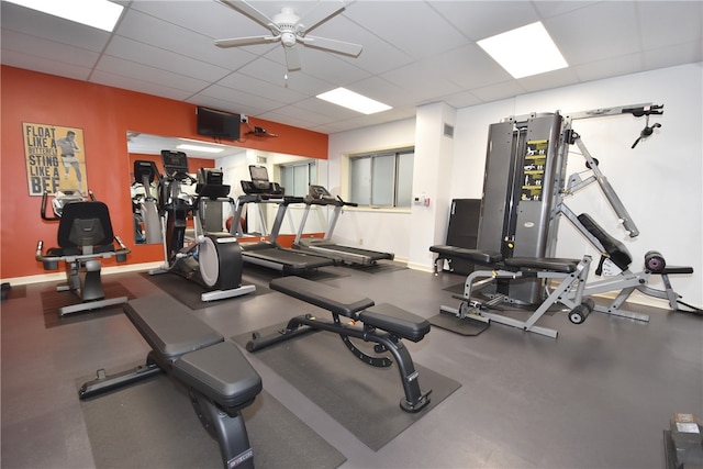 exercise room with a drop ceiling and ceiling fan