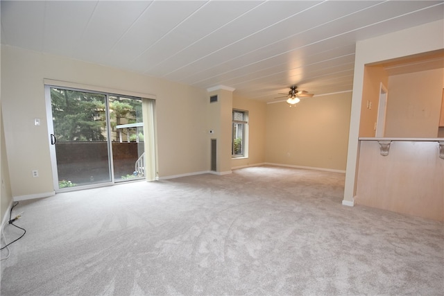 carpeted spare room with ceiling fan