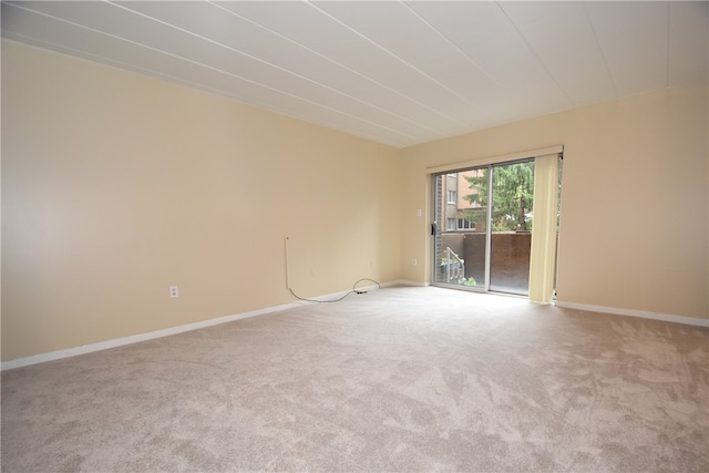 unfurnished room featuring light colored carpet