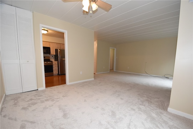 empty room with ceiling fan and light colored carpet