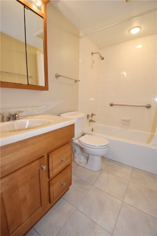 full bathroom featuring tile patterned floors, tiled shower / bath, vanity, and toilet