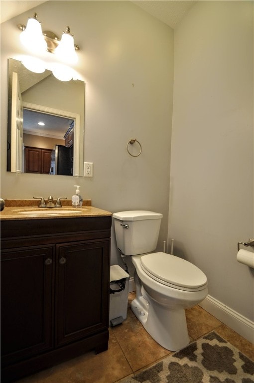 bathroom with vanity, toilet, and tile patterned floors