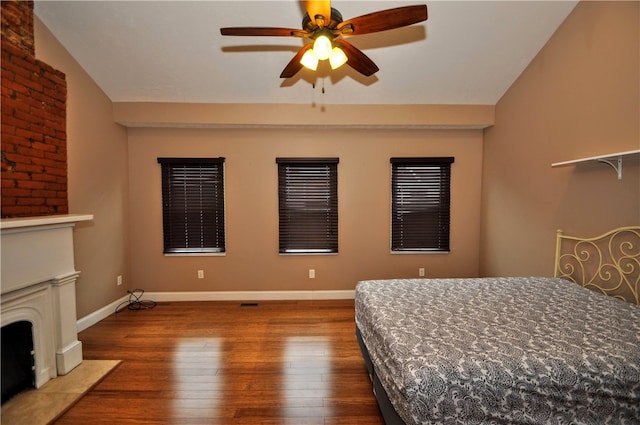 unfurnished bedroom with ceiling fan, hardwood / wood-style floors, and vaulted ceiling