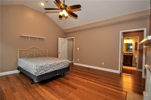 bedroom featuring ceiling fan, ensuite bathroom, dark wood-type flooring, and vaulted ceiling