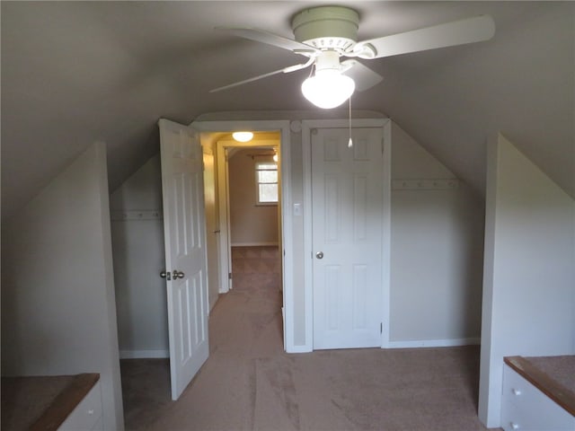 additional living space featuring lofted ceiling, light colored carpet, and ceiling fan