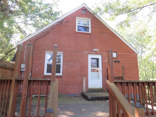 rear view of property with a wooden deck