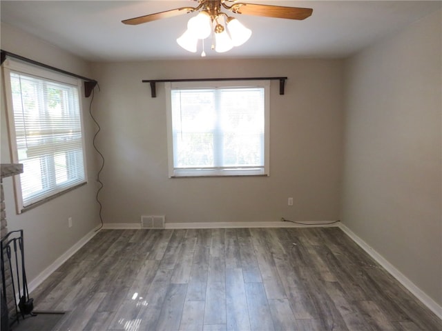 spare room with dark wood-type flooring and ceiling fan