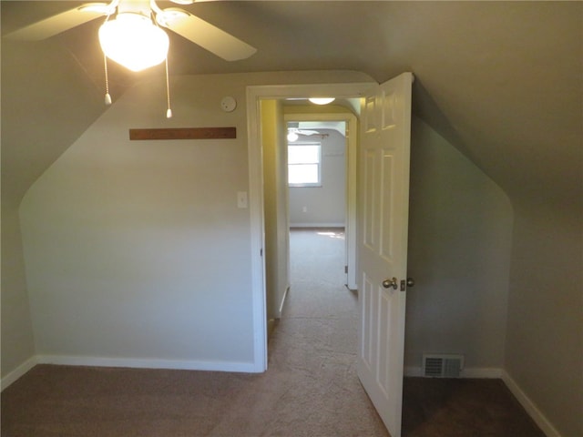 bonus room featuring ceiling fan, vaulted ceiling, and light colored carpet