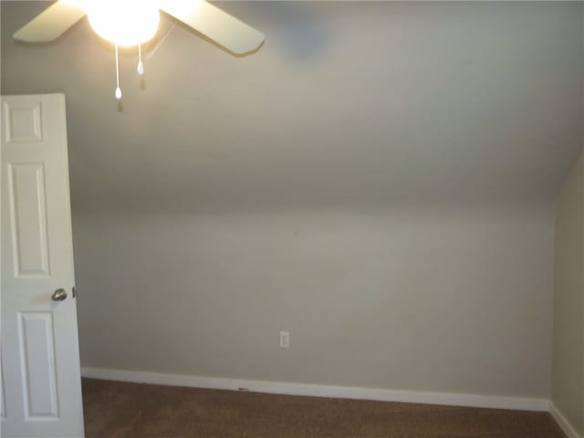 empty room with dark carpet and ceiling fan