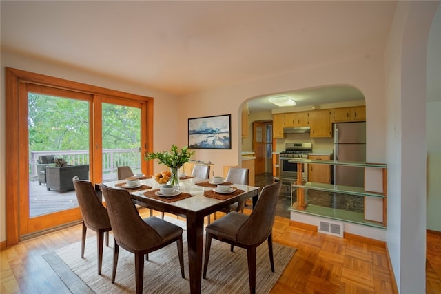 dining space with light parquet floors