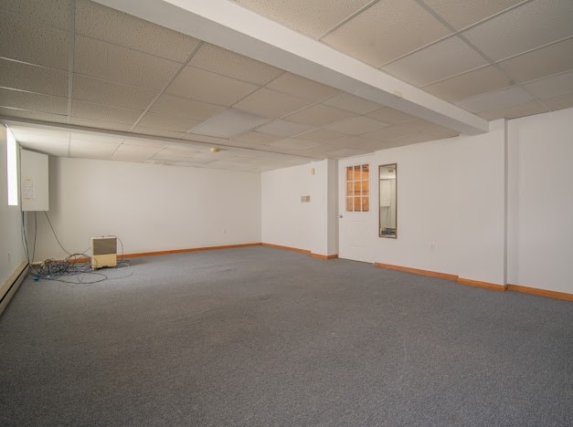 basement with carpet flooring and a drop ceiling