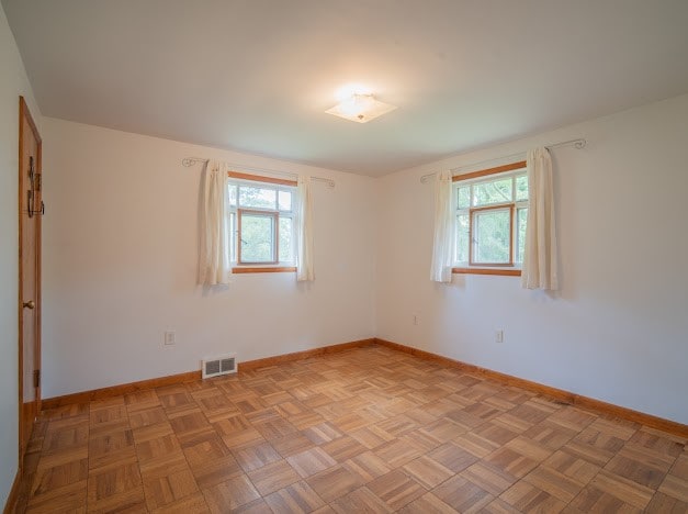 unfurnished room with light parquet floors