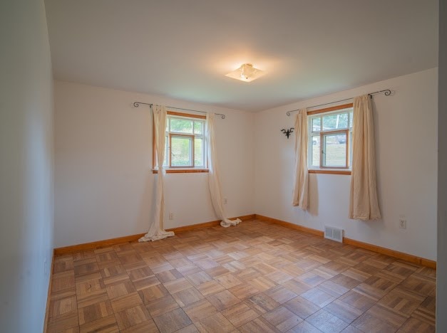 unfurnished room with parquet floors