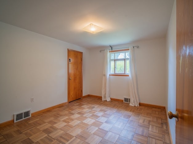 spare room featuring light parquet flooring