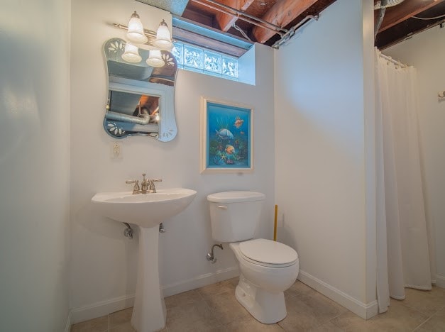 bathroom with tile patterned floors and toilet