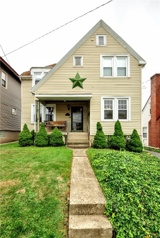 view of front of property featuring a porch and a front lawn