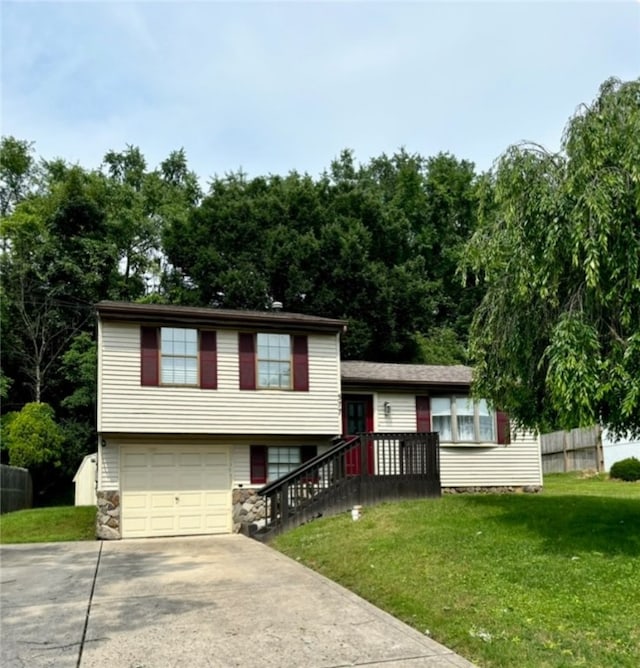 view of front of home with a garage and a front lawn