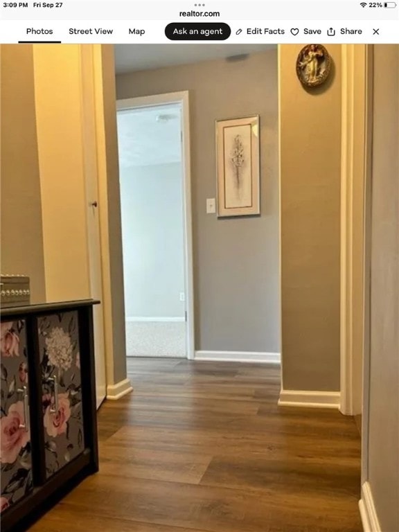 corridor with hardwood / wood-style flooring