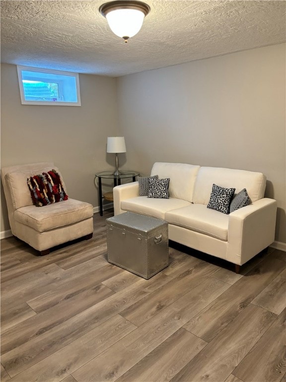 living room with wood-type flooring and a textured ceiling