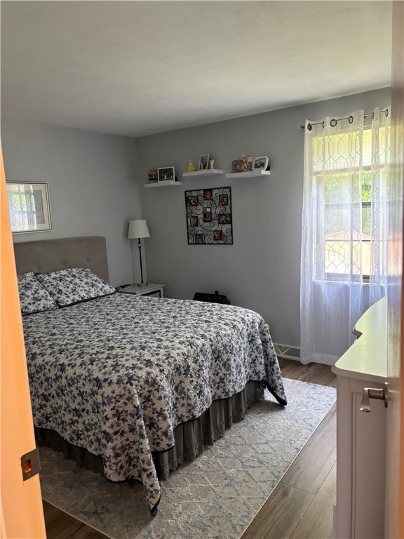 bedroom with hardwood / wood-style flooring