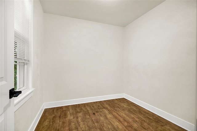 unfurnished room with wood-type flooring