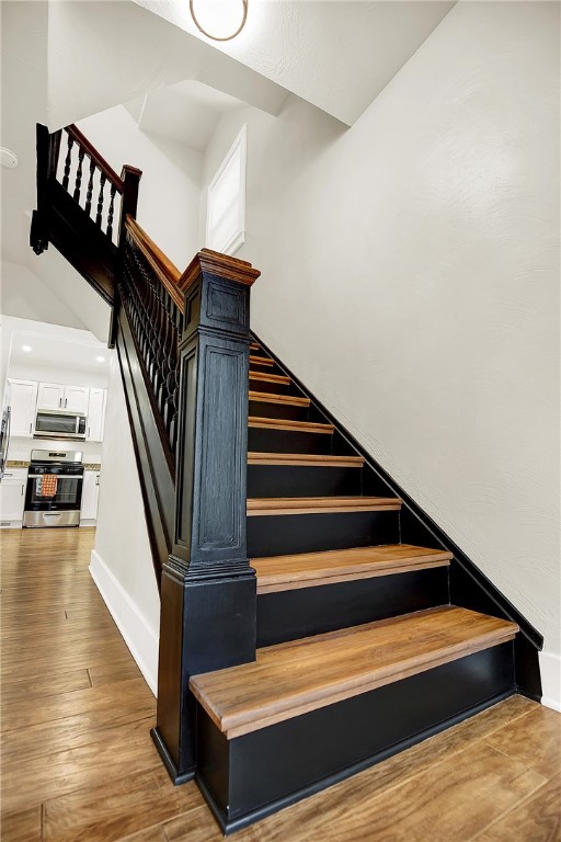 stairway featuring hardwood / wood-style flooring