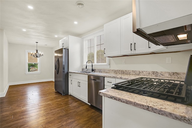 kitchen with white cabinets, sink, appliances with stainless steel finishes, and dark hardwood / wood-style flooring