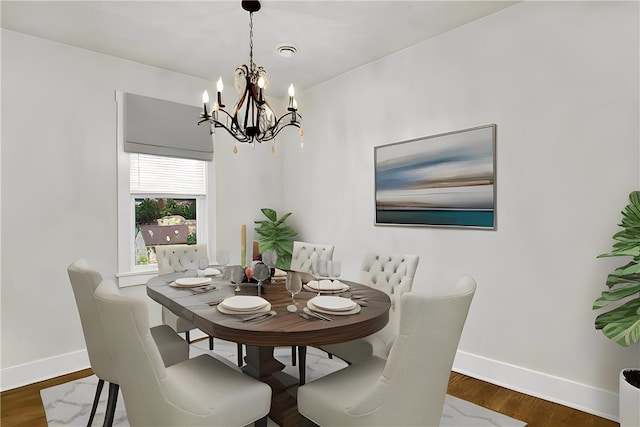 dining room featuring a notable chandelier and dark hardwood / wood-style floors