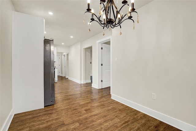 interior space featuring an inviting chandelier and dark hardwood / wood-style floors