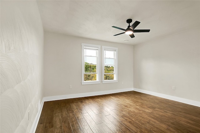 spare room with ceiling fan and dark hardwood / wood-style flooring