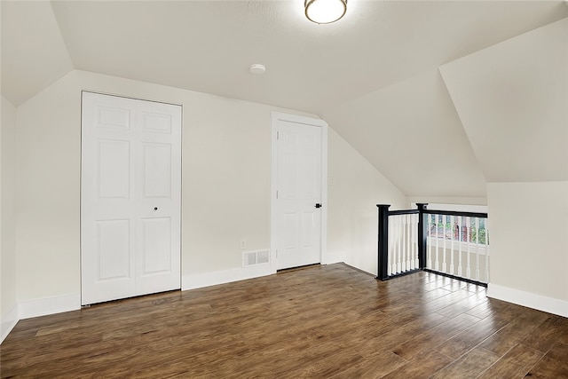 bonus room featuring lofted ceiling and dark wood-type flooring