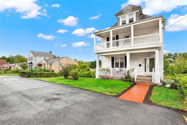 view of front of house featuring a front lawn and covered porch