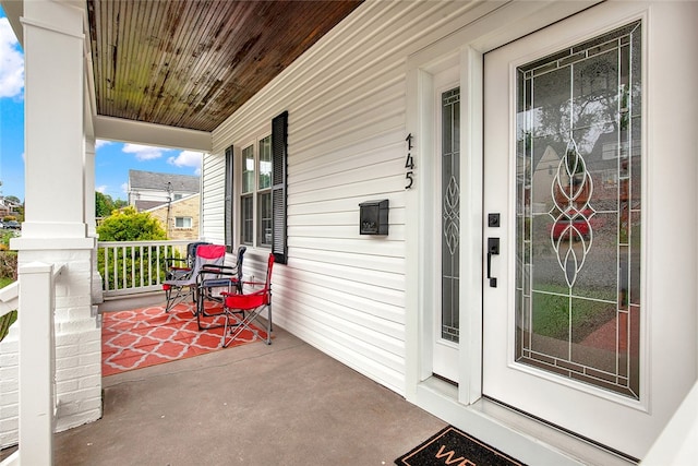 property entrance with covered porch