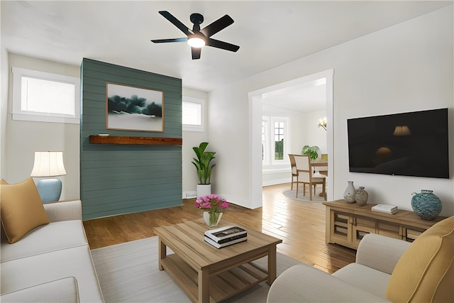 living room featuring ceiling fan and hardwood / wood-style flooring