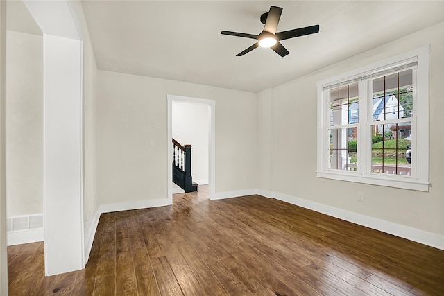 empty room with ceiling fan and dark hardwood / wood-style floors