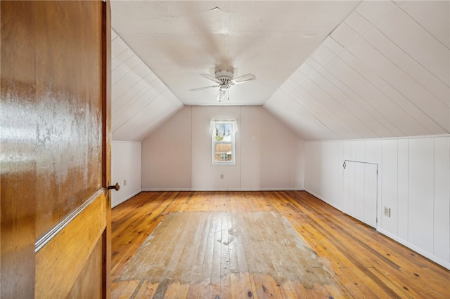 additional living space with light wood-type flooring, lofted ceiling, and ceiling fan