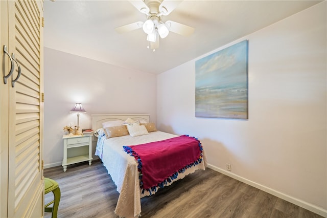 bedroom with ceiling fan and dark wood-type flooring