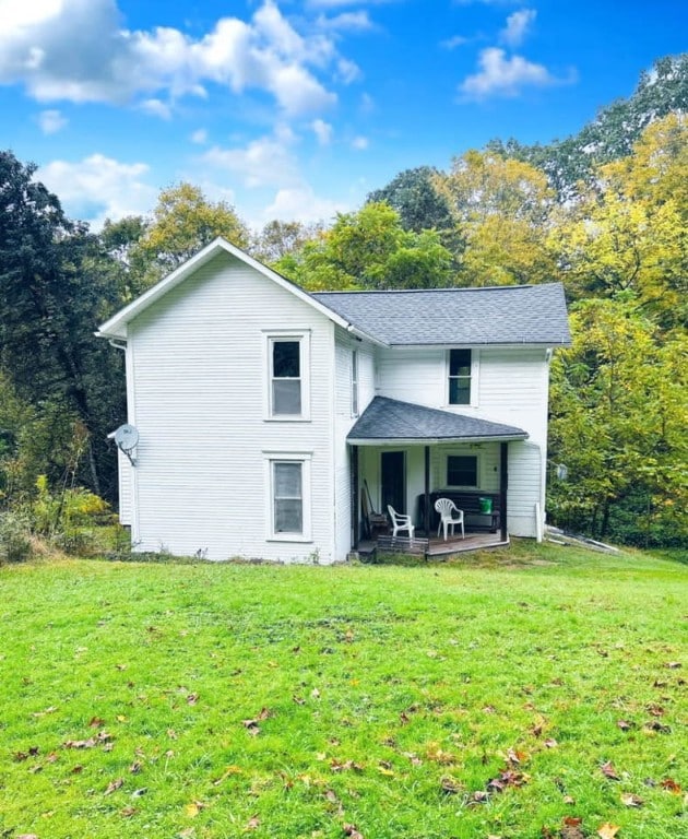 rear view of property with a yard