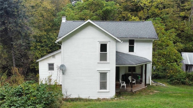 rear view of property with a yard