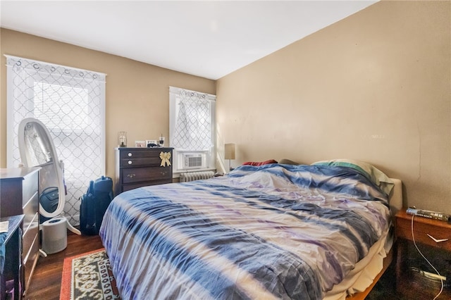 bedroom featuring dark hardwood / wood-style flooring and radiator heating unit