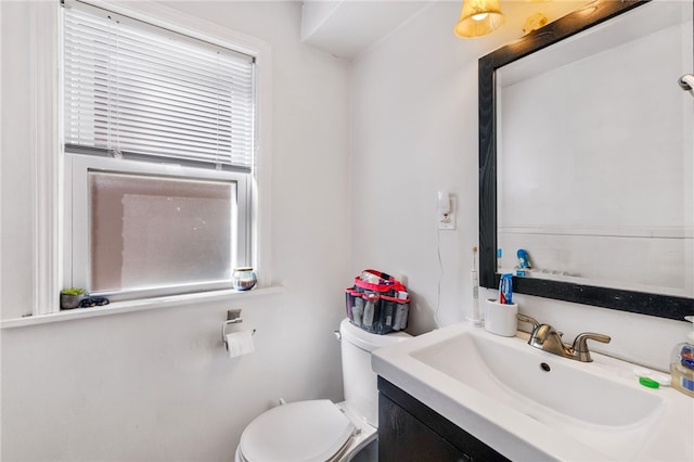 bathroom with vanity, toilet, and a wealth of natural light