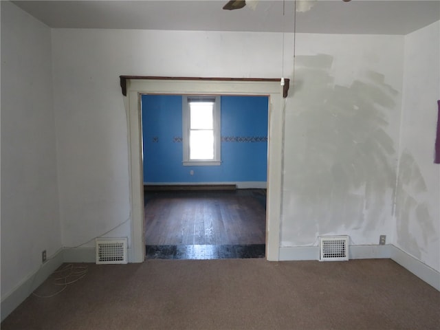 empty room with dark hardwood / wood-style floors and ceiling fan