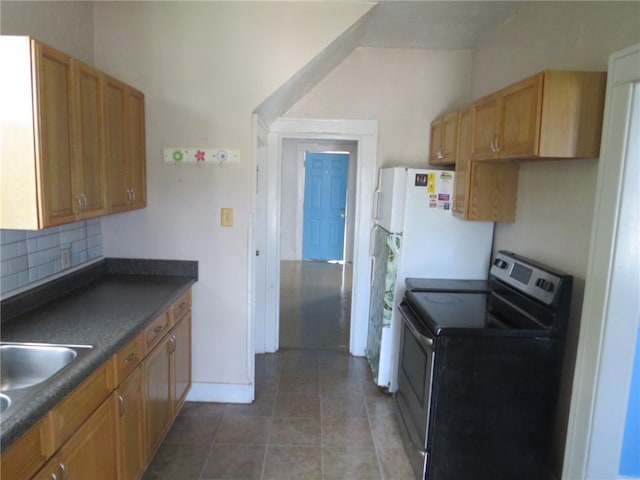 kitchen featuring backsplash, stainless steel electric stove, sink, and tile patterned floors